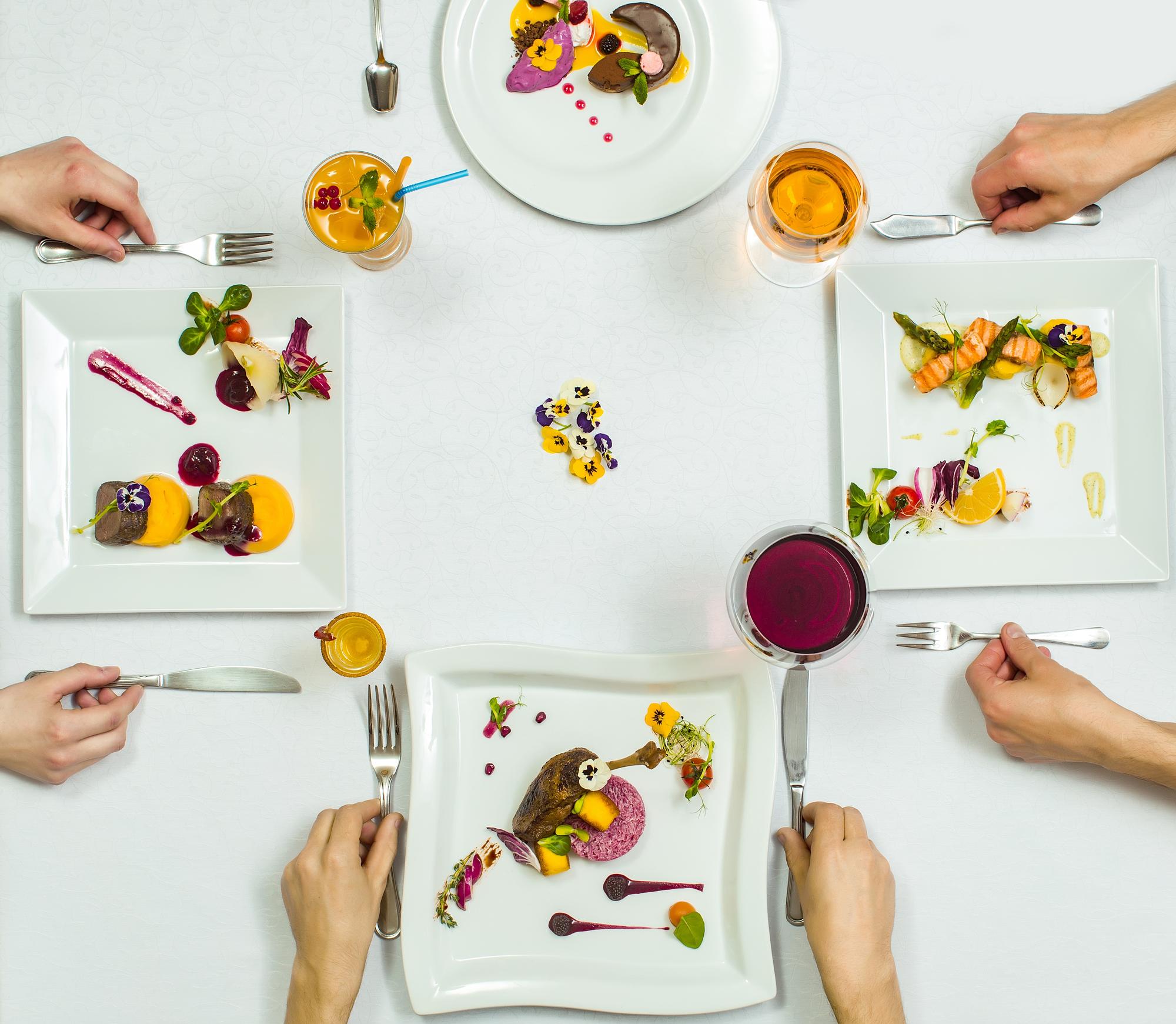 Group around a table tasting a plated course